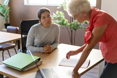 Women chatting at work - FMLA Retaliation